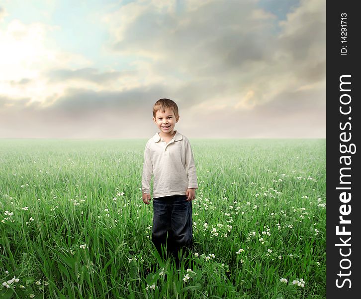 Smiling child standing on a green lawn. Smiling child standing on a green lawn