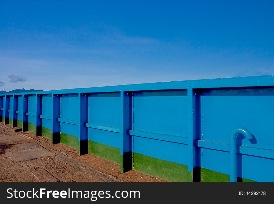 Blue metal wall near sea. Blue metal wall near sea