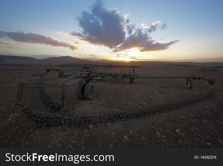 Image of a farm implement at Sunset in the Western Cape Province in South Africa. Image of a farm implement at Sunset in the Western Cape Province in South Africa