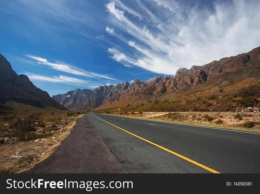 Road through the mountains in South Africa in the Western Cape with great High clouds. Road through the mountains in South Africa in the Western Cape with great High clouds