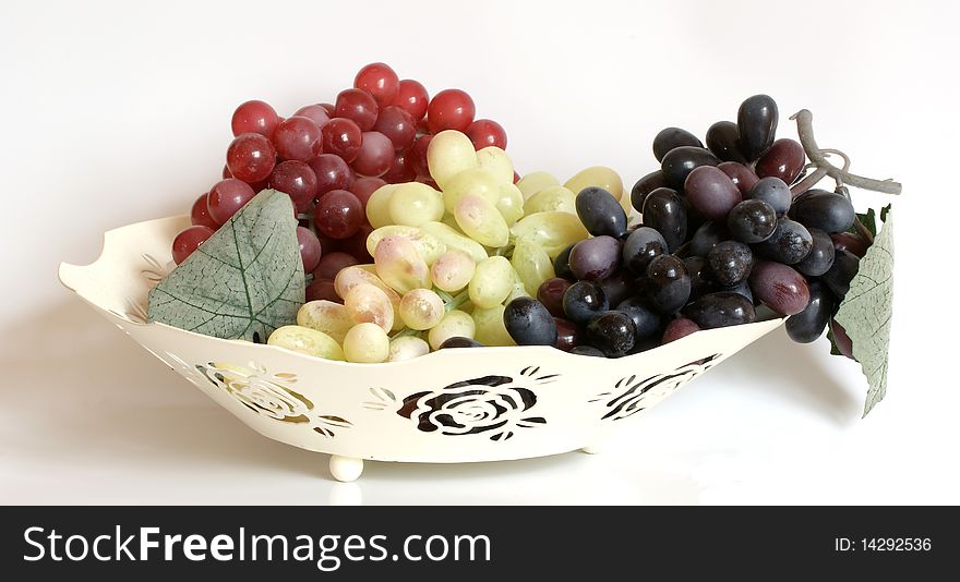 Still Life with ripe grapes on a white background