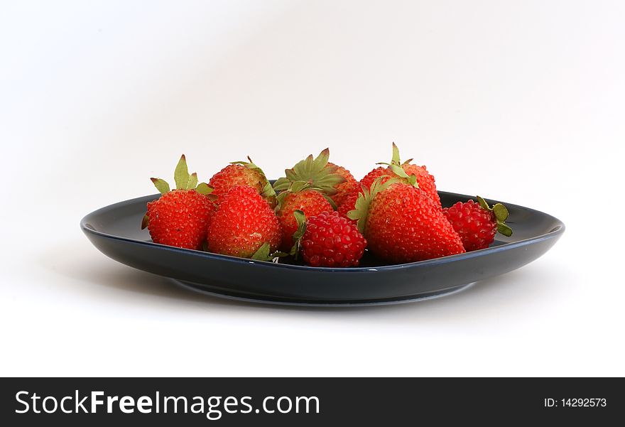 Red Strawberries On A Black Plate