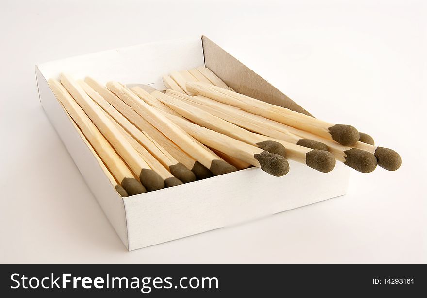 Big matches with brown heads closeup on white background.