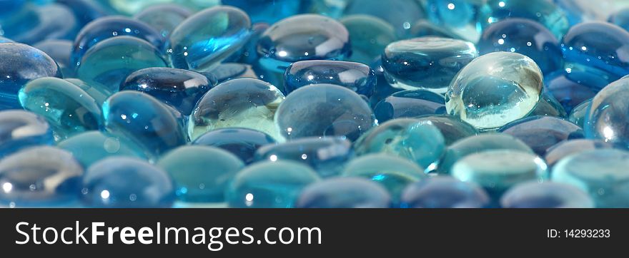 Background of brilliant blue glass stones, close-u