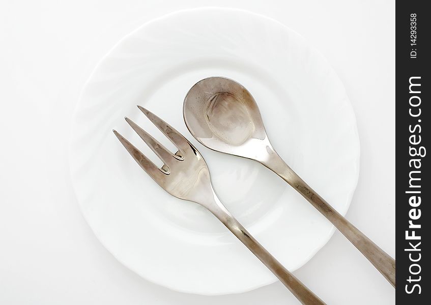 An image of fork and spoon on a plate