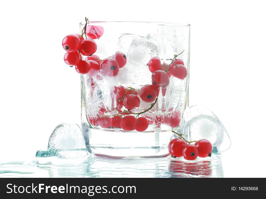 Red currant in the glass with an ice. Isolated on white background. Red currant in the glass with an ice. Isolated on white background