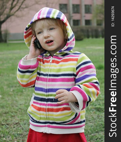 Little girl talking on the phone for a walk