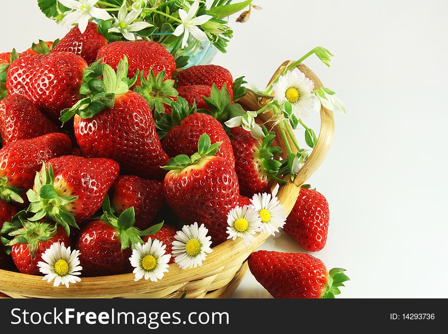 Strawberries and daisies in a wicker basket