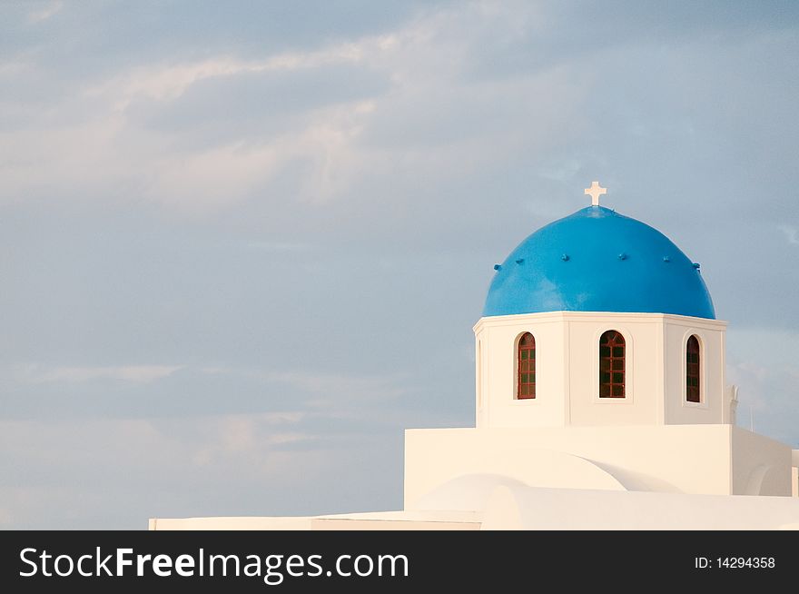 Greek church in santorini greece with a cross