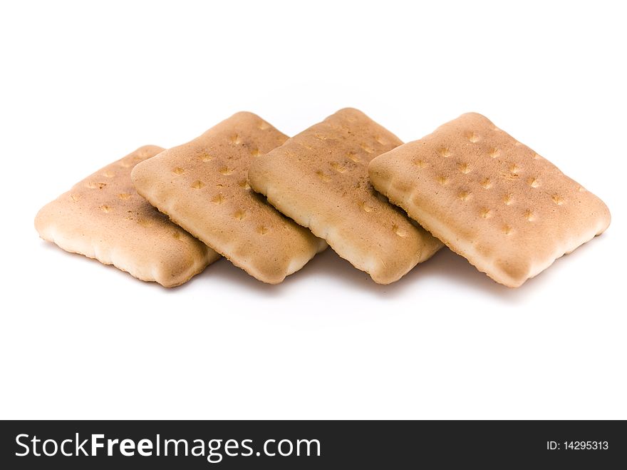 Four delicious sweet biscuits, lying one on another in a row, isolated on a white background. Four delicious sweet biscuits, lying one on another in a row, isolated on a white background