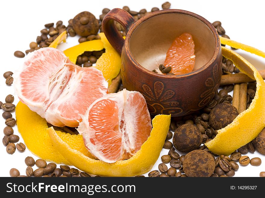 Peeled grapefruit and a cup