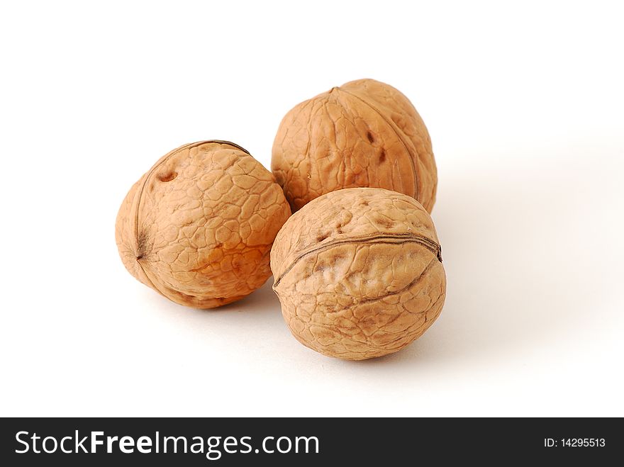 Three walnuts isolated on white background