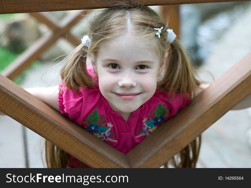 Smiling little girl in a wooden structures