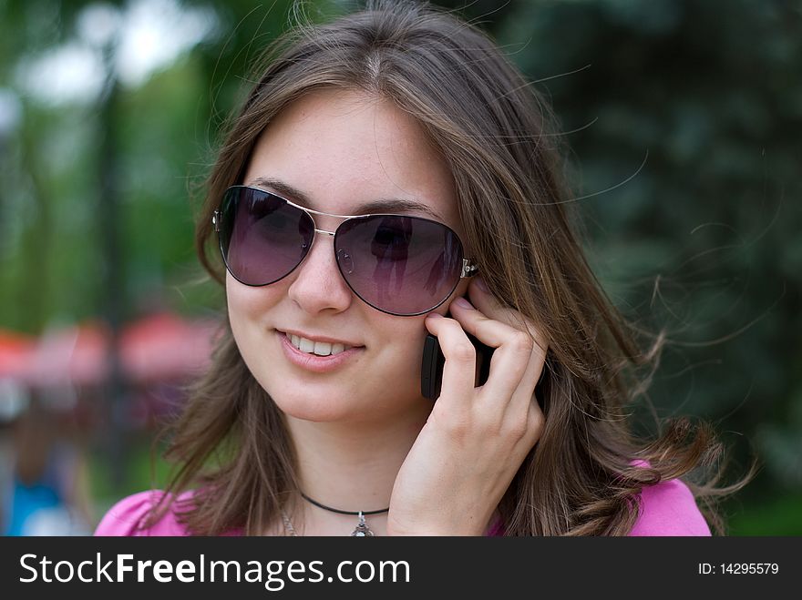 Portrait of a beautiful teenage girl in sunglasses with mobile phone. Portrait of a beautiful teenage girl in sunglasses with mobile phone