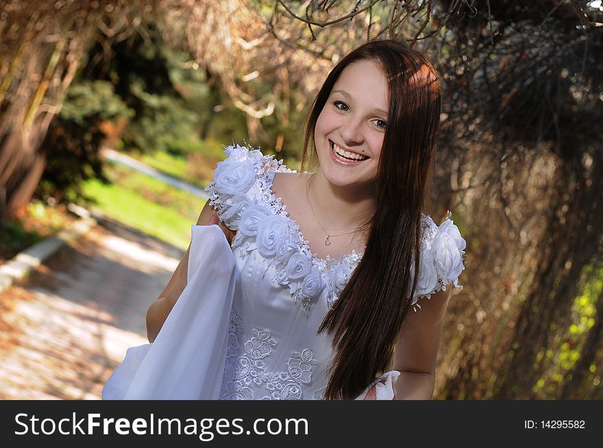 Portrait of the bride in a white dress with in spring garden