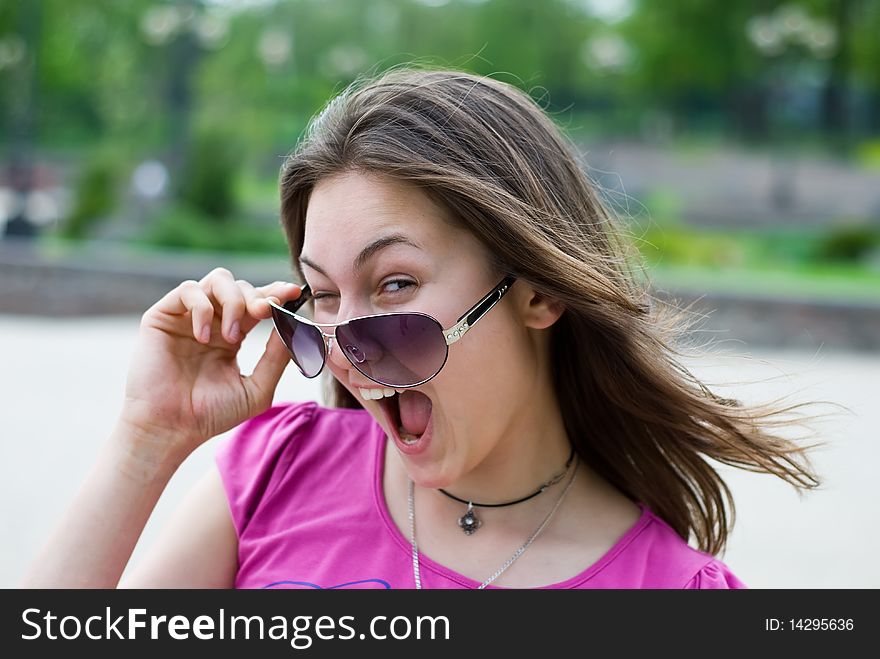 Portrait of a laughing teenage girl in sunglasses. Portrait of a laughing teenage girl in sunglasses