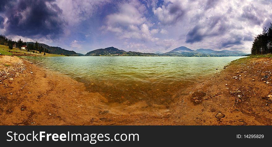 Lake panorama in a cloudy day of spring