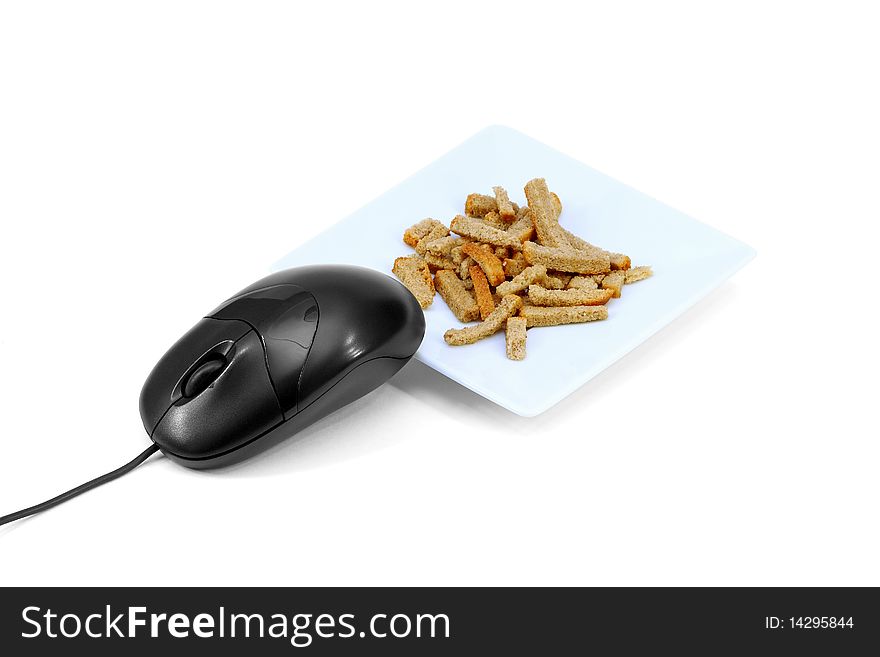 Computer mouse in front of a plate of biscuits on a white background. Concept