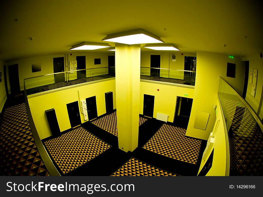 Spacious internal hall in a modern hotel in funky yellow light. Spacious internal hall in a modern hotel in funky yellow light