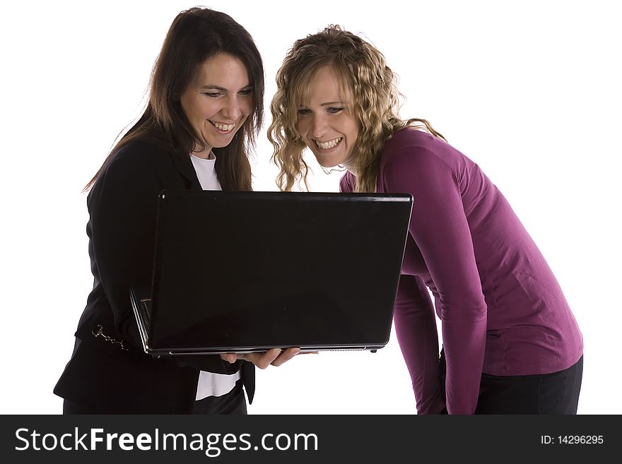 Two business women looking at a project on the computer with excited expressions on their faces. Two business women looking at a project on the computer with excited expressions on their faces.