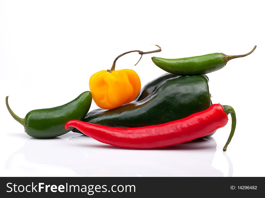 Five hot peppers in an interesting arrangement on a white background