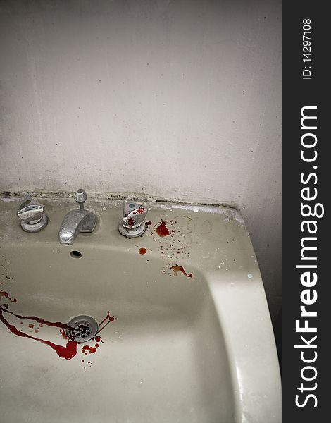 Desaturated image of splashes of blood in an old sink, with a vignette effect. Desaturated image of splashes of blood in an old sink, with a vignette effect.