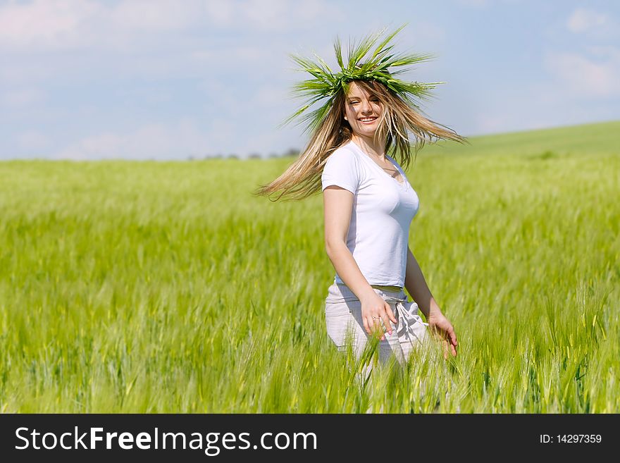 Young happy girl in green field