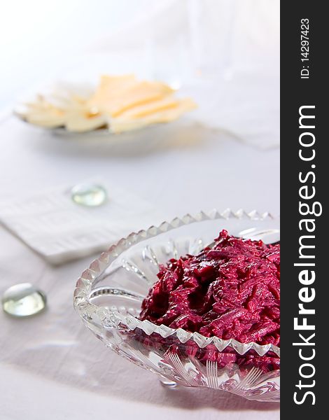 Salad from red beet on glass plate