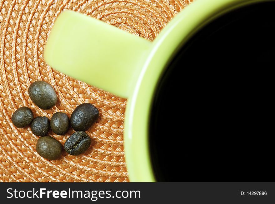 Coffee beans beans and a mug of coffee