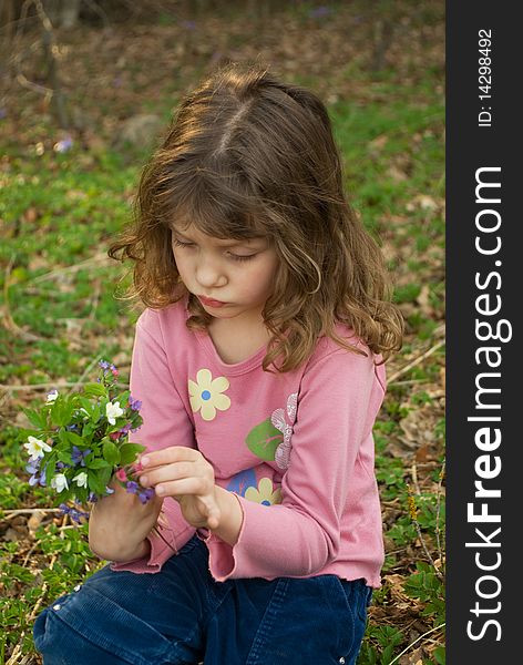 Little upset girl with bouquet of snowdrops. Little upset girl with bouquet of snowdrops