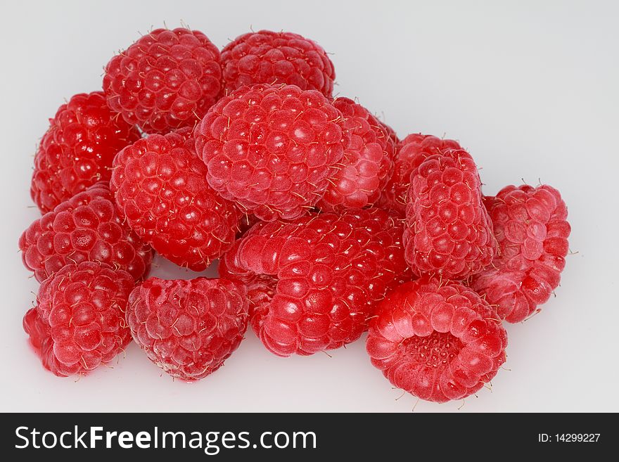 Clump of fresh, ripe raspberries isolated on a white background. Clump of fresh, ripe raspberries isolated on a white background