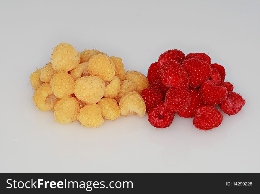 Clump of fresh, ripe red and golden  raspberries isolated on a white background. Clump of fresh, ripe red and golden  raspberries isolated on a white background