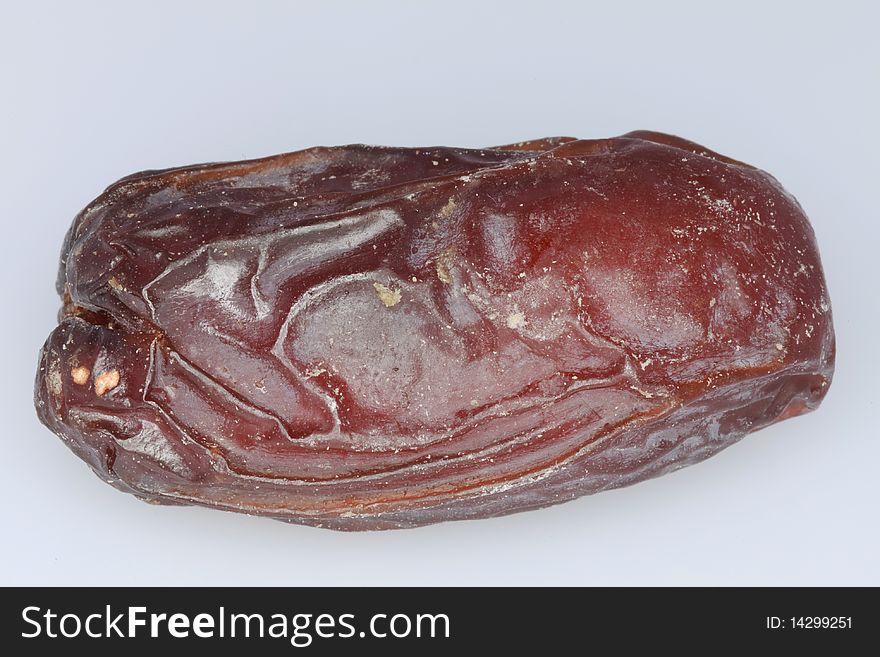 Macro of a Medjool date isolated on a white background. Macro of a Medjool date isolated on a white background