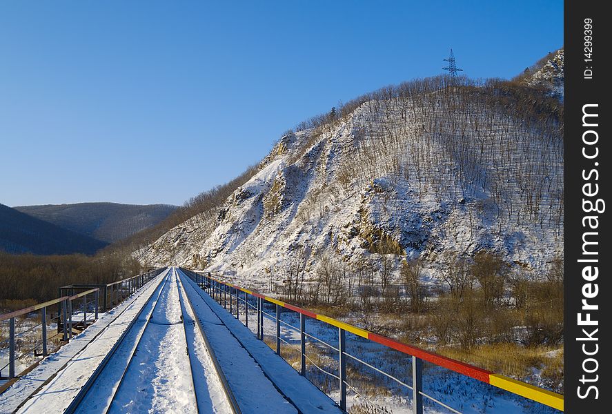 Winter landscape with the railway bridge at a mountain slope. Winter landscape with the railway bridge at a mountain slope