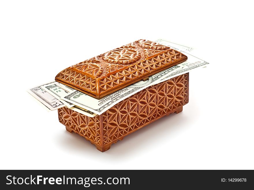 Dollars in wooden box isolated on white. With shadow