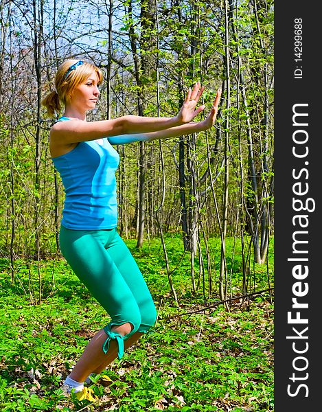 Young woman doing exercises outdoors