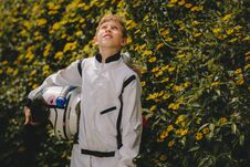 Boy Astronaut Standing Outdoors And Looking Up Stock Photo