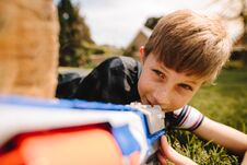 Cute Boy Playing With Toy Gun In Playground Stock Image