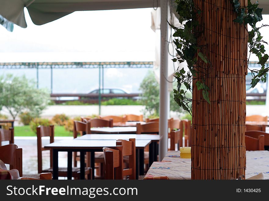 Terrace restaurant with bamboo column, tables and chairs