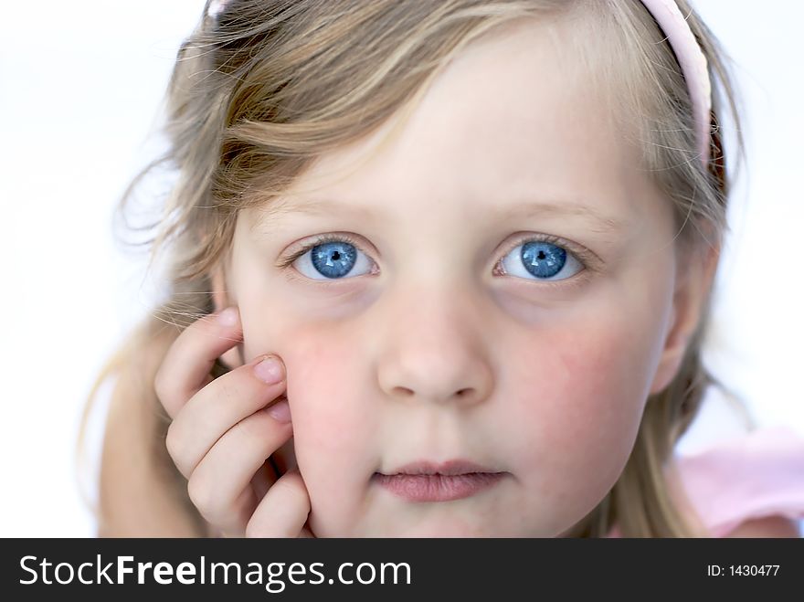 Close up of face of young girl: blue eyes, blonde hair. Close up of face of young girl: blue eyes, blonde hair