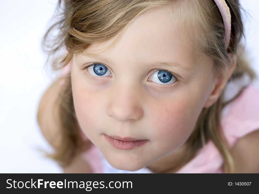 Close up of face of young girl: blue eyes, blonde hair. Close up of face of young girl: blue eyes, blonde hair