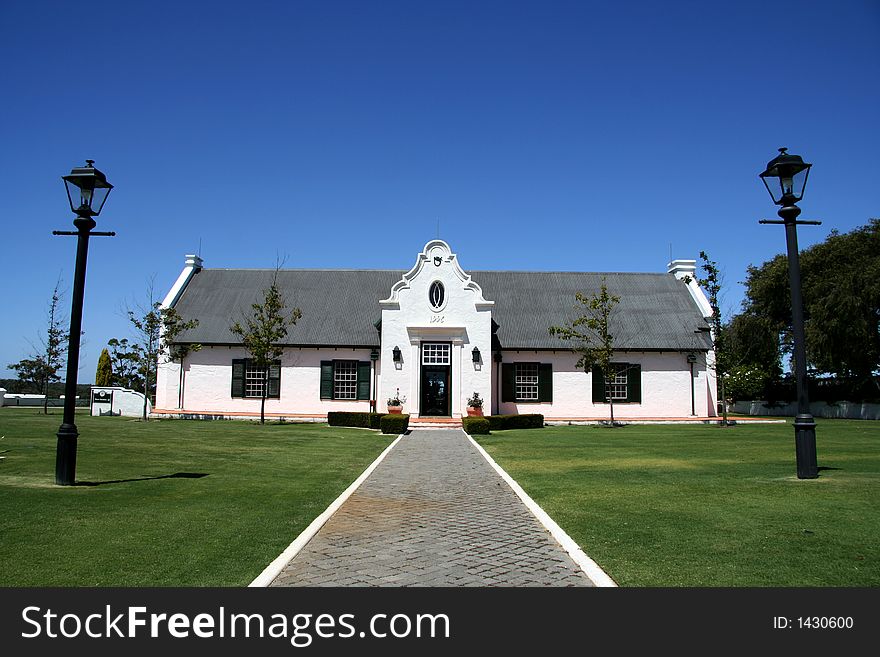 A country cottage with lush green lawn in front