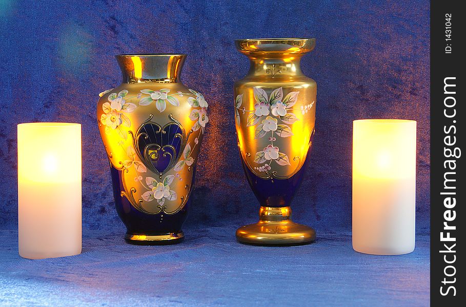 Blue-gold vases, candles, Blue background. Blue-gold vases, candles, Blue background