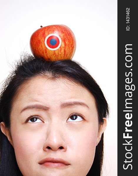 An apple on top of girl head. An apple on top of girl head