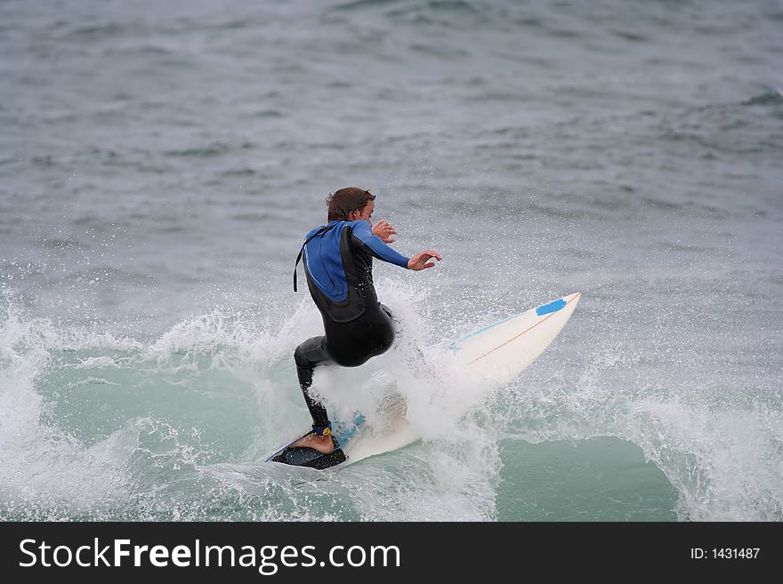 Surfer in the wave with a white board