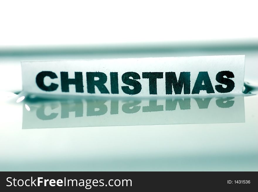 Card floating on water surface with printed word: CHRISTMAS. Card floating on water surface with printed word: CHRISTMAS