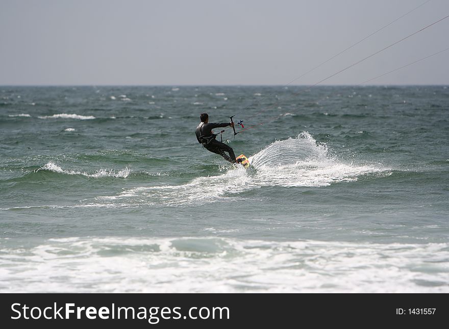 Kitesurfer in the sea with a blue sky