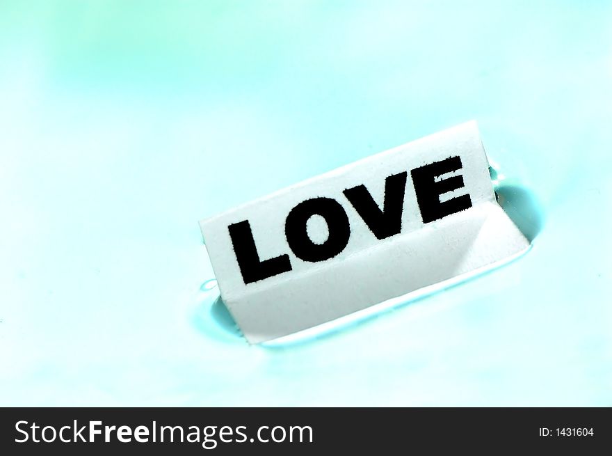 Card floating on water surface with printed word: LOVE. Card floating on water surface with printed word: LOVE