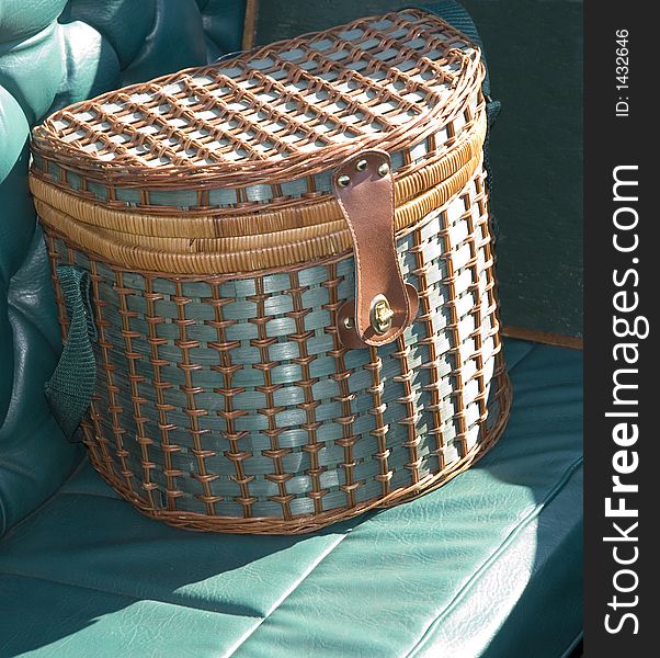 Blue wicket picnic basket on a boat