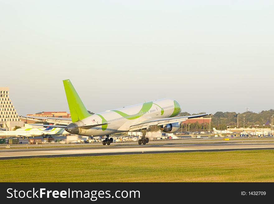 Airliner about to touchdown at a busy airport. Airliner about to touchdown at a busy airport